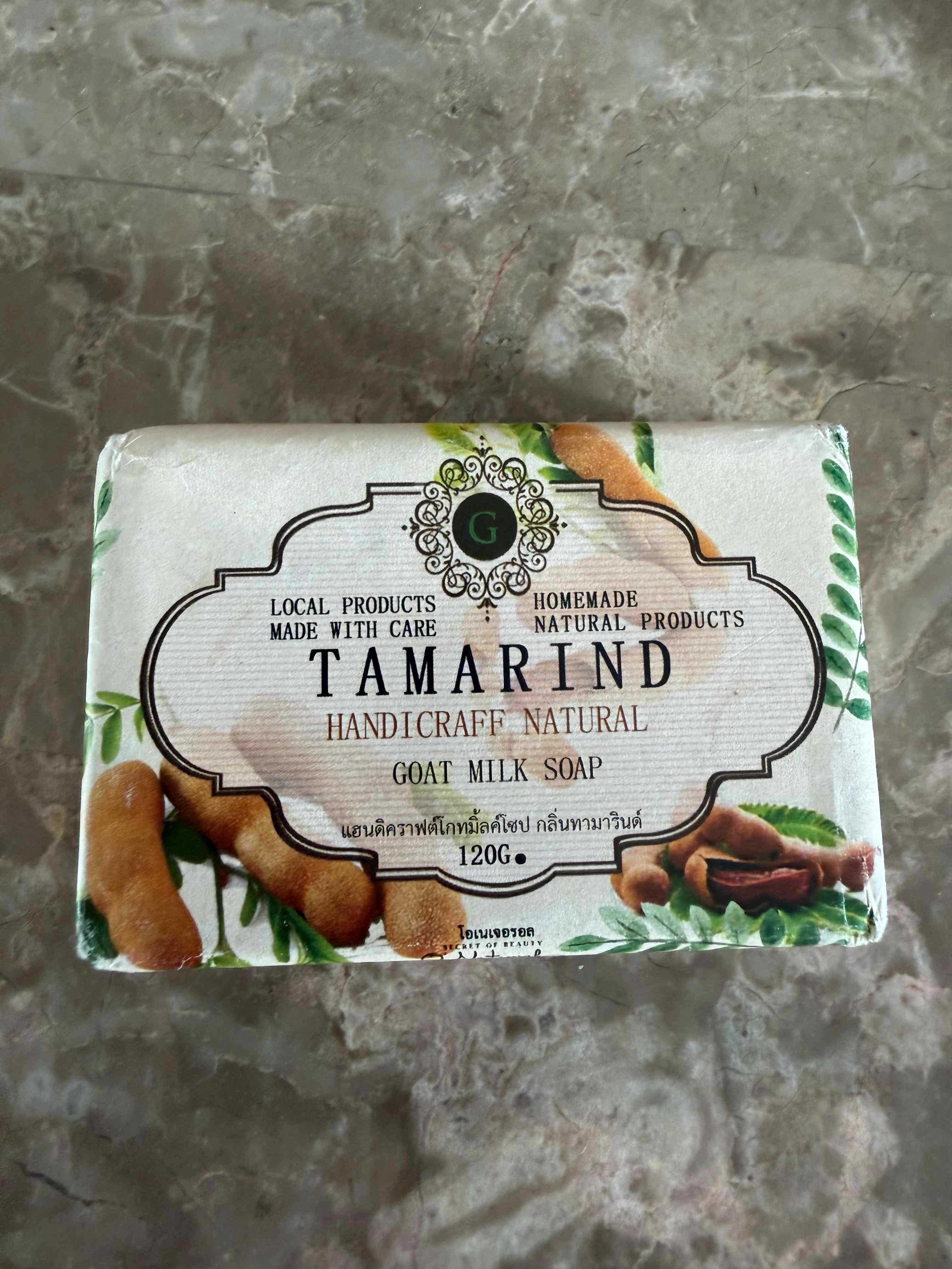 Bar of tamarind goat milk soap on a gray surface